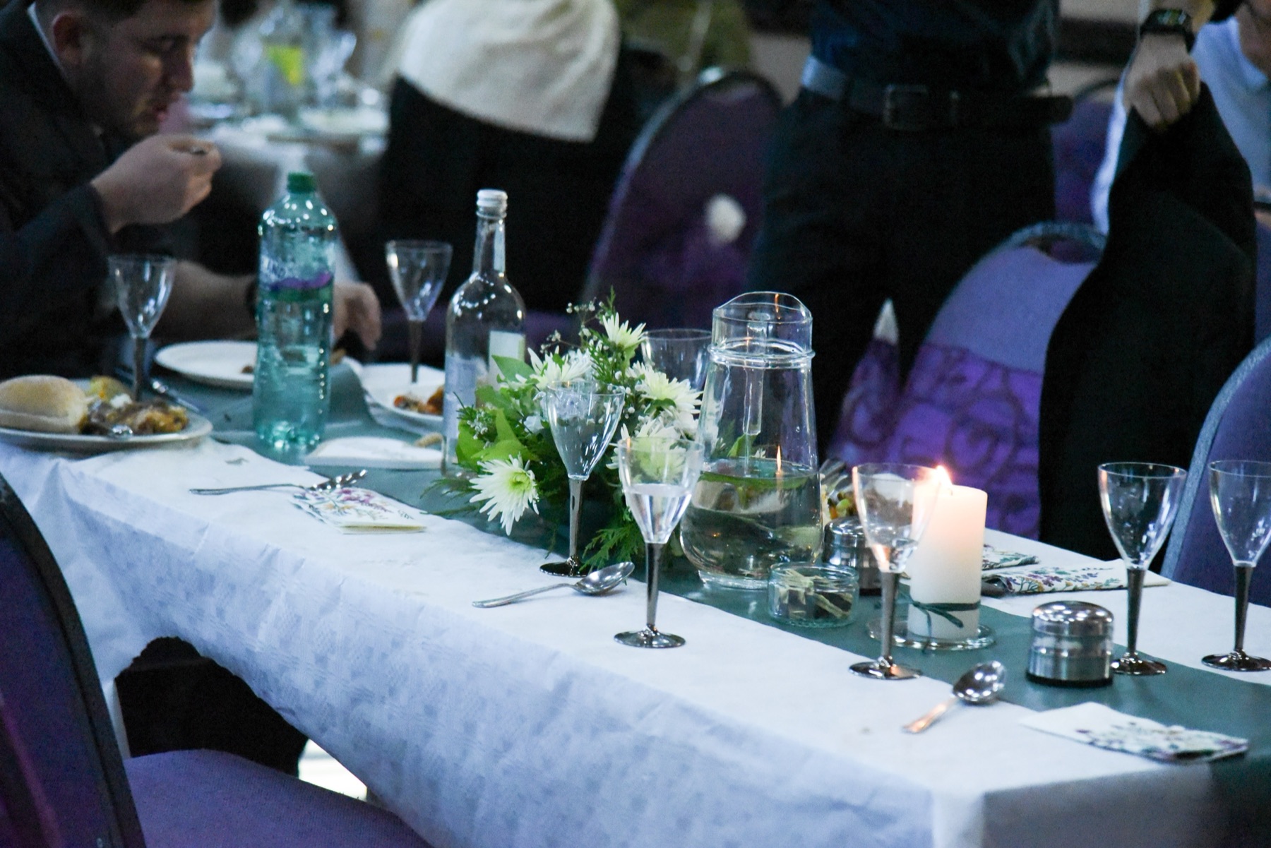 Flowers and candles arranged on a wedding reception table